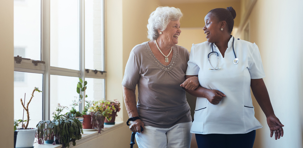 woman with care giver at assisted living facility