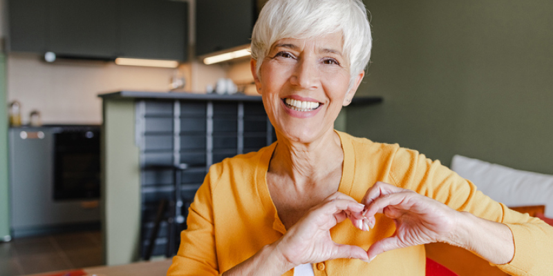 happy Senior woman making a heart